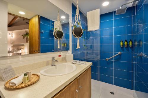 a bathroom with a sink and a blue tiled wall at Casa Bixa Hotel Boutique by HMC - Mayores de 12 años - in Santa Fe de Antioquia