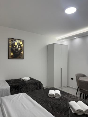 a bedroom with two beds with towels on them at Apartmani Zabjelo in Podgorica