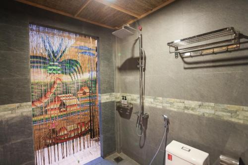 a bathroom with a shower with a painting on the wall at Mekong Rustic Riverside in Ấp An Nhơn (3)
