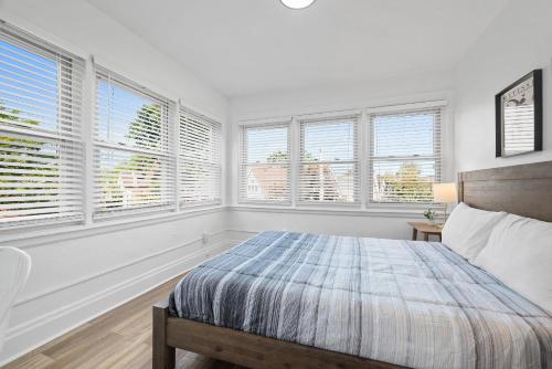 a bedroom with white walls and windows with a bed at Pittsburgh Shadyside 3A Bright and Stylish Private Bedroom with Shared Bathroom in Pittsburgh