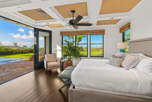 a bedroom with a bed and a ceiling fan at Luxury 6BR Ocean View Estate Home in Kukuiula in Kukuiula