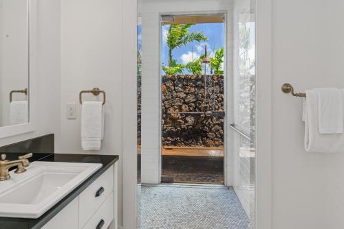 a white bathroom with a sink and a shower at Luxury 6BR Ocean View Estate Home in Kukuiula in Kukuiula