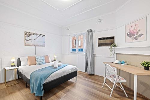 a bedroom with a bed and a desk at Boutique Double Room - Centrally Located at Granville - Shared Bathroom in Sydney