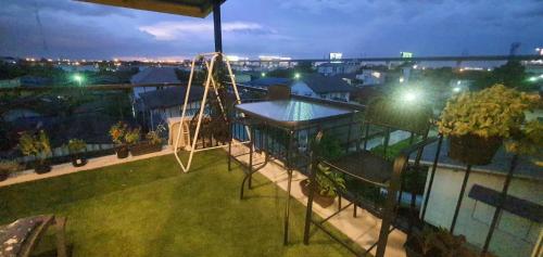 an aerial view of a playground on a balcony at night at Merit Courtyard Suvarnabhumi House in Lat Krabang