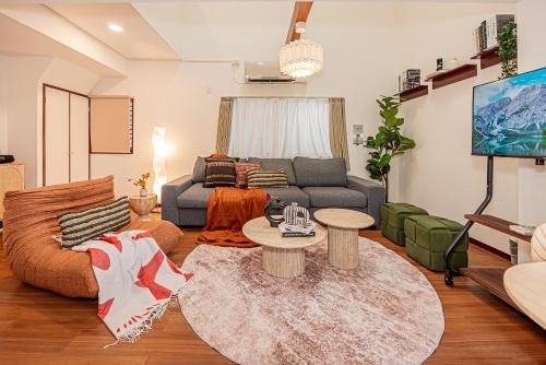 a living room with a couch and a table at Mi-APT Kitashinjuku in Tokyo