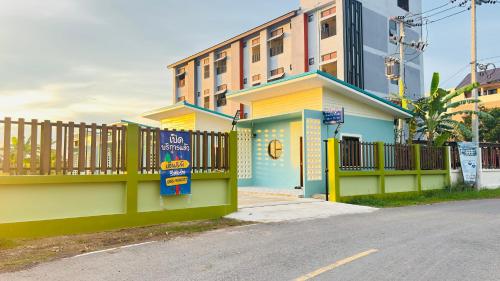 een gebouw met een uithangbord aan de zijkant van een straat bij เอ็นแอนด์พี รีสอร์ทบุรีรัมย์ in Ban Don Wai