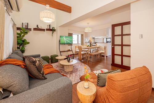 a living room with a couch and a table at Mi-APT Kitashinjuku in Tokyo