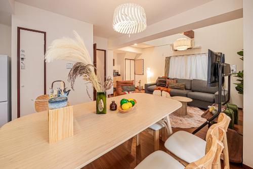 a kitchen and living room with a table and a couch at Mi-APT Kitashinjuku in Tokyo