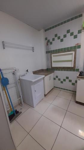 a kitchen with a sink and a tiled floor at Paraiso das Aguas in Marcelino Ramos