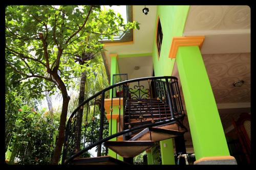 a building with a staircase with green and orange at Hostal San Antonio in León