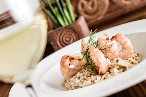 a plate of shrimp on rice on a table at Hotel Restaurant Lilie in Vipiteno
