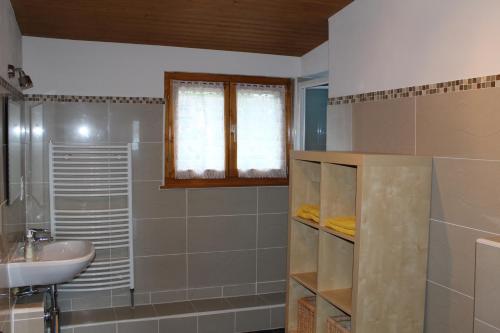 a bathroom with a sink and a toilet and a mirror at Au cœur du vignoble sur Bursins in Bursins