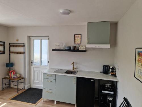 a kitchen with a sink and a counter top at La Cabaña - Studio apartment between Leap and Rosscarbery in Leap