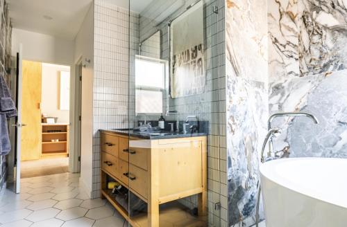 a bathroom with a sink and a tub at Simple La Jolla Epic bungalow #1 in San Diego