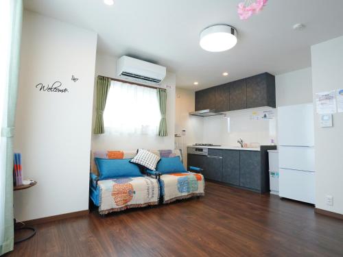 a living room with a couch and a kitchen at Newly built house in Ota Ward,6 minutes from the station in Tokyo