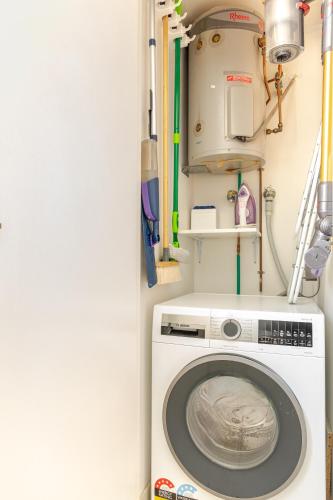a laundry room with a washing machine at Stylish and perfectly located Bondi Beach hideaway in Sydney