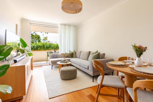 a living room with a couch and a table at Stylish and perfectly located Bondi Beach hideaway in Sydney