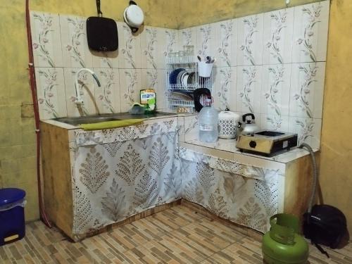 a kitchen with a counter and a sink in a room at 563 Homestay Jogja in Ngabean