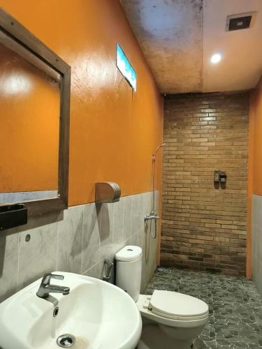 a bathroom with a white sink and a toilet at Wanajaya Homestay by ABM in Terong