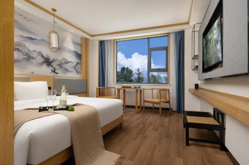 Postel nebo postele na pokoji v ubytování 博雅酒店张家界国家森林公园店