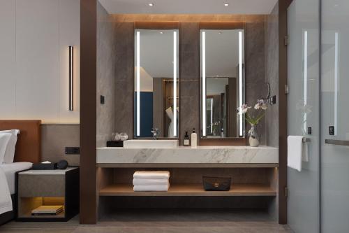 Ένα μπάνιο στο 长沙温德姆花园酒店-世界之窗芒果馆店