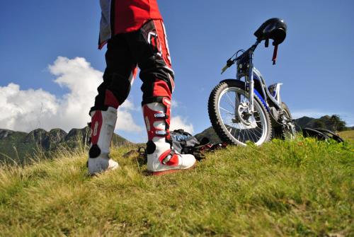 a person standing next to a bike on a hill at Albergo Legazzuolo Montecampione in Artogne