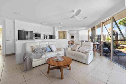 a living room with a couch and a table at Sandcastles On Currumbin Beachfront, Gold Coast in Gold Coast
