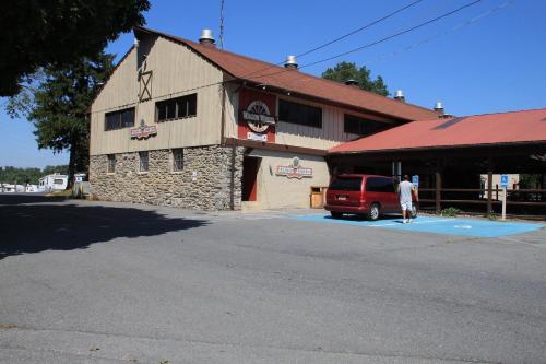 a man is standing in front of a building at Circle M Camping Resort Loft Park Model in Wabank