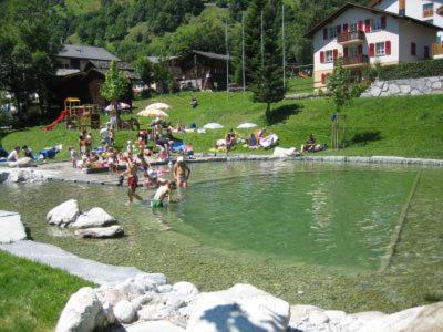 a group of people in the water at a lake at Studio Bel-Hüs / Bel-Häx in Blatten bei Naters