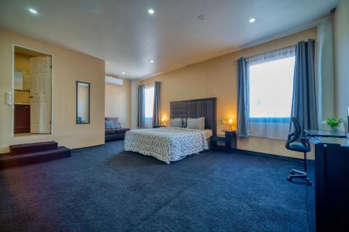 a hotel room with a bed and a television at Costero Inn in Ensenada