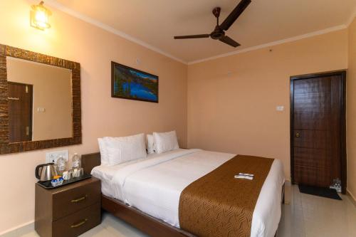 a bedroom with a bed and a ceiling fan at NAZRI THE VERDA HOTEL, Arambol in Arambol
