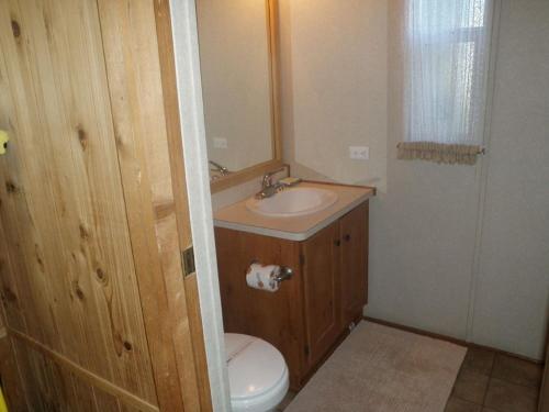 a small bathroom with a sink and a toilet at Seaside Camping Resort Studio Cabin 3 in Seaside