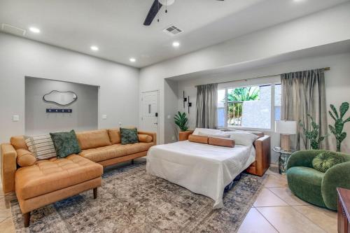 a living room with a couch and a bed at The Golden Hour Getaway Pool Lake Views Games in Abbeyville