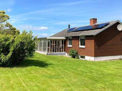 a house with a solar roof on a yard at 6 person holiday home in Augustenborg in Augustenborg