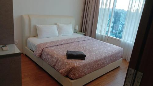 a hotel room with a bed with a large window at Vortex klcc by amira suites in Kuala Lumpur