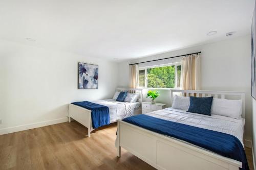 a bedroom with two beds and a window at Lux MV Home Live Like A Local Backyard Oasis in Mission Viejo
