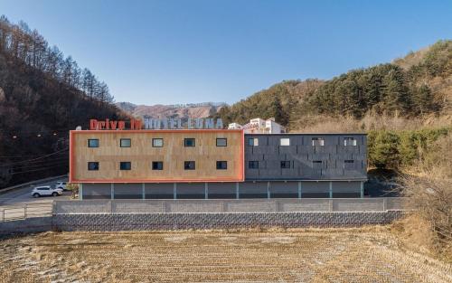 a building on the side of a road at Chuncheon Gangchon Luna Pension in Kugong-ni