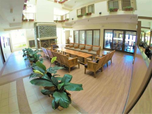 a large room with tables and chairs in a building at 2-BR Condo near Major Tourist Spots in Baguio in Sampong