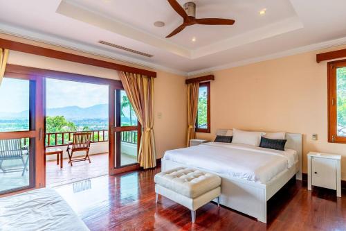 une chambre avec un lit et un balcon dans l'établissement Luxurious Phuket Escape - Lakewood Hills, à Layan Beach