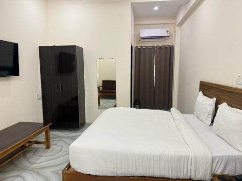 a hotel room with a bed and a television at Hotel O stay inn in Shivāpur