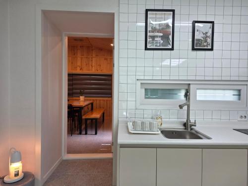 a kitchen with a sink and a dining room at Stay33 Pet friendly house near Hwangridangil in Gyeongju