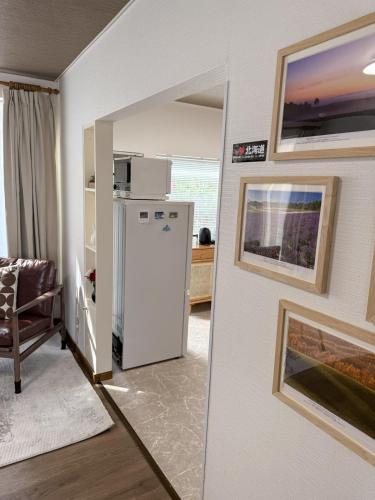 a kitchen with a white refrigerator in a room at Sappro Teine House in Sapporo