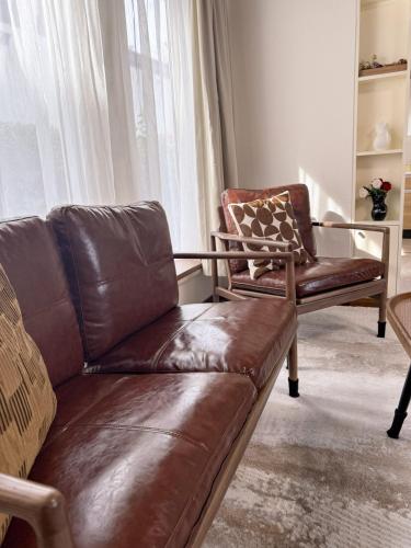 a couch and a chair in a living room at Sappro Teine House in Sapporo