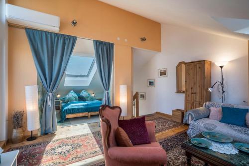 a living room with a couch and a chair at Haus Himmelblick mit privater Sauna in Sasbach am Kaiserstuhl