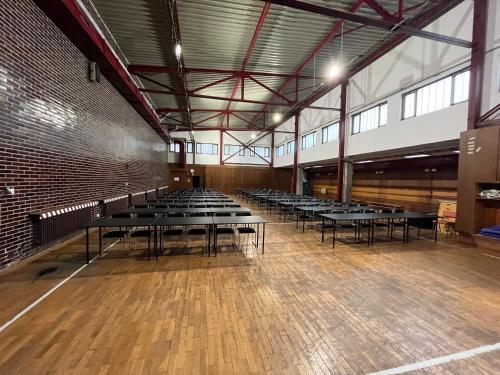 una grande stanza con file di tavoli al suo interno di Sportcentrum Brandýs a Brandýs nad Labem-Stará Boleslav