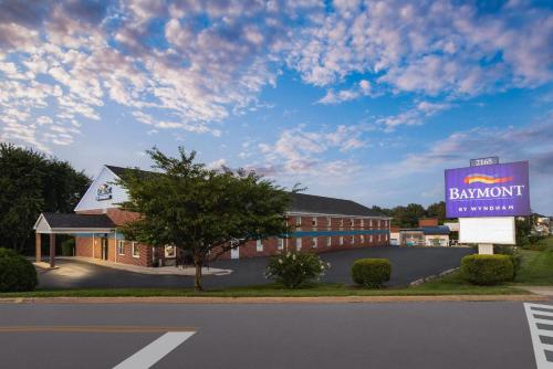 a rendering of a building with a sign in front at Baymont by Wyndham Lancaster PA Dutch Country in Lancaster