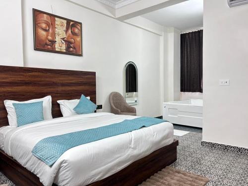 a bedroom with a large bed with blue pillows at Abharam Retreats in Ghaziabad