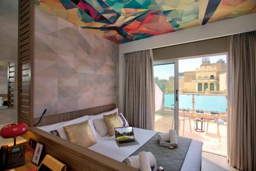 a bedroom with a bed and a colorful ceiling at Casual Kubic Athens by Casual Hoteles in Athens