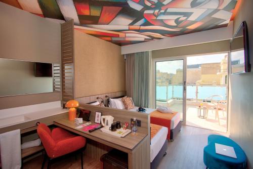 a hotel room with a bed and a desk and a room at Casual Kubic Athens in Athens