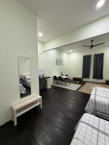 a living room with a bed and a mirror at cozy nest panji in Kota Bharu
